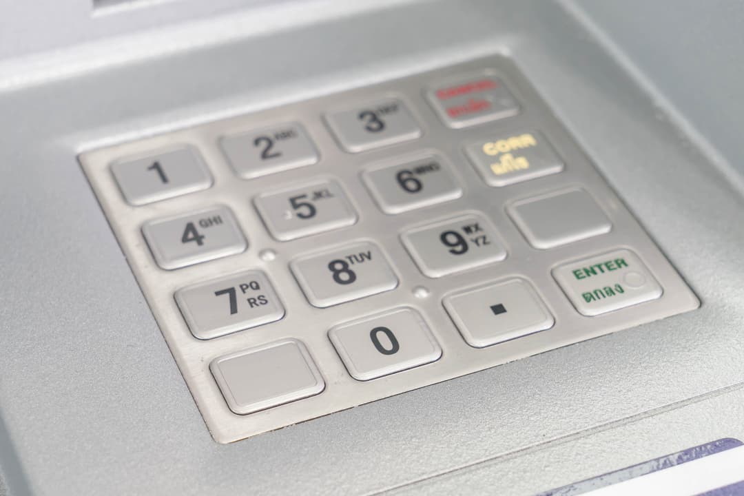 Close-up of an ATM keypad highlighting numeric buttons and function keys.